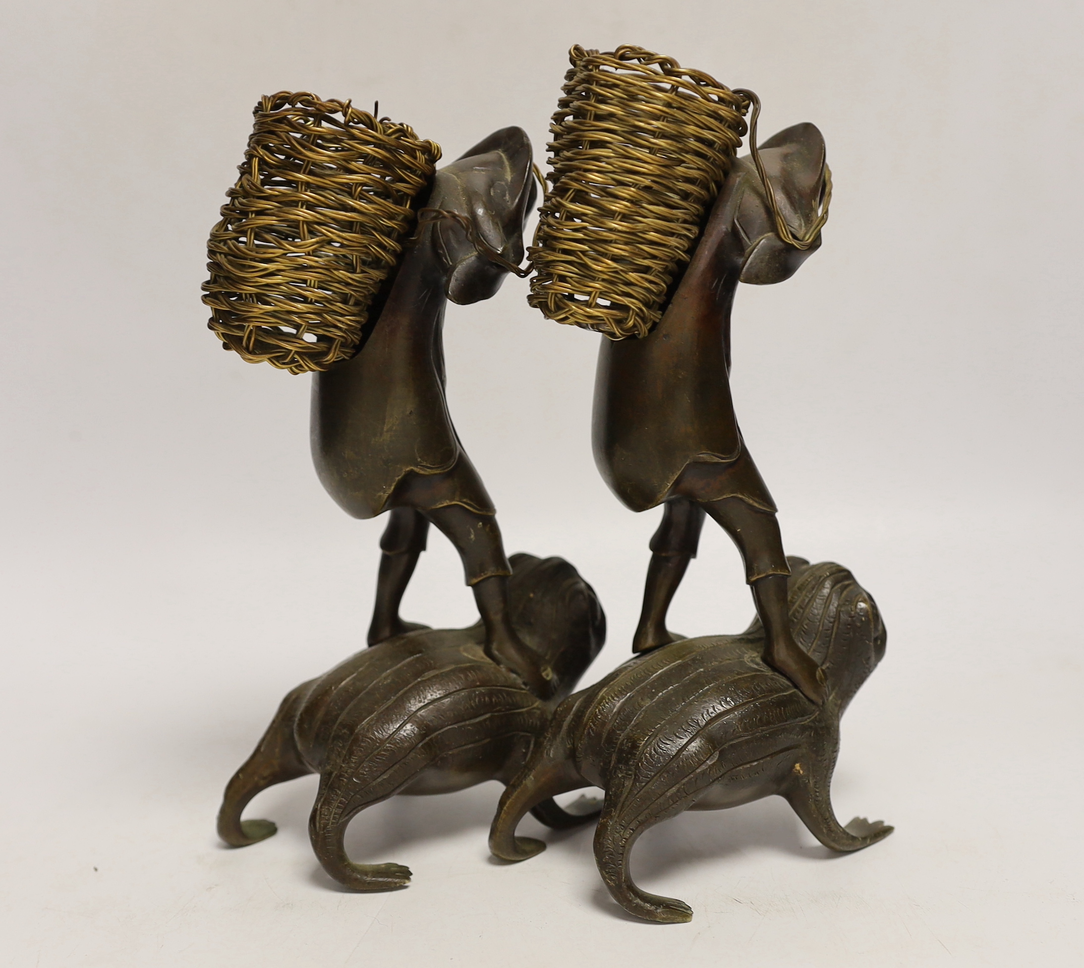 A pair of Japanese bronze boys on a toads, 22cm